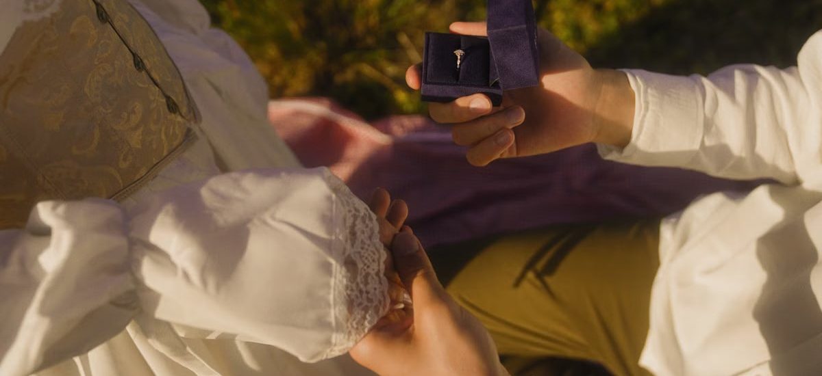Vintage-inspired outdoor proposal with engagement ring and romantic atmosphere.